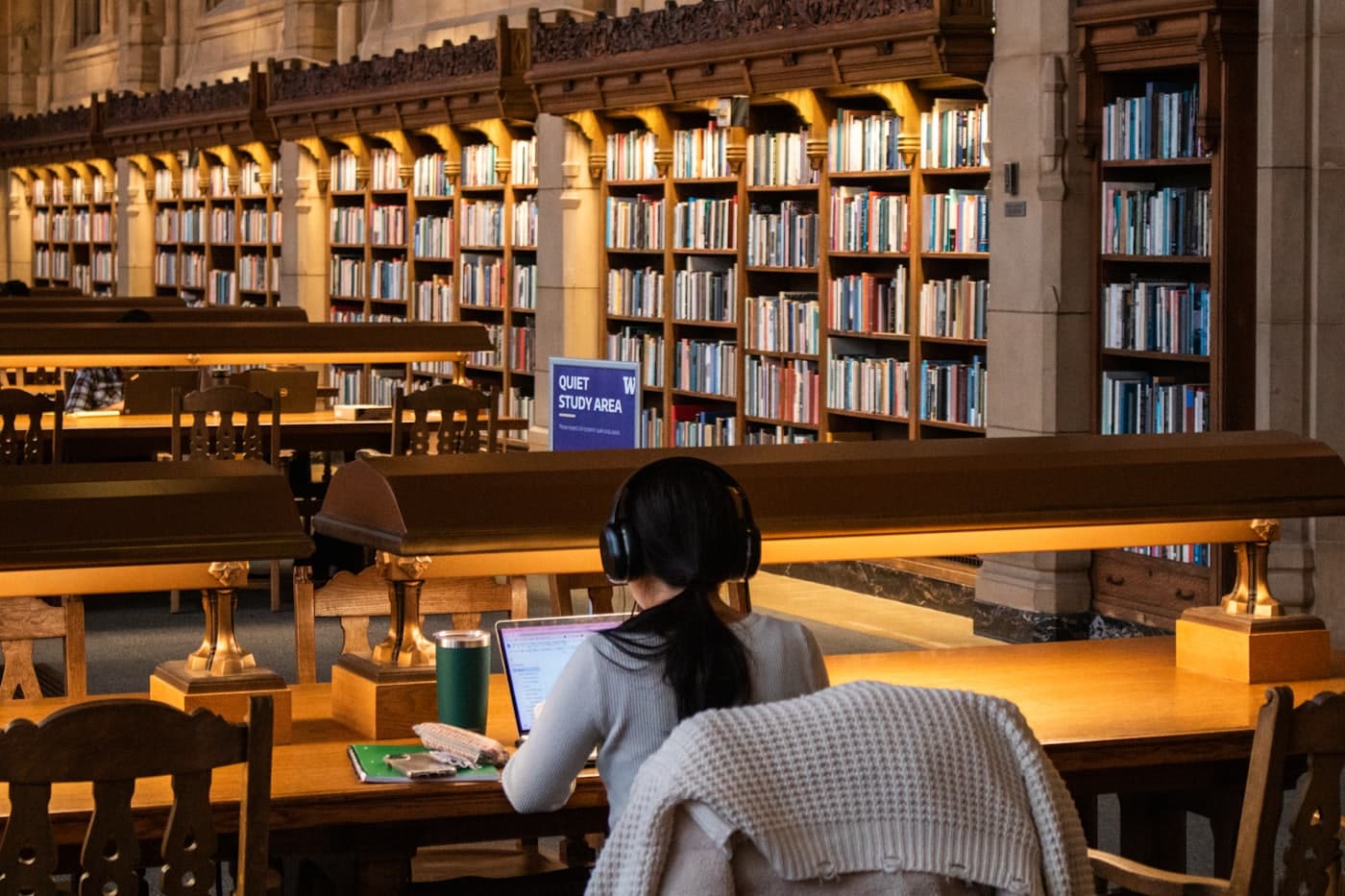 A student working on a laptop in a university library